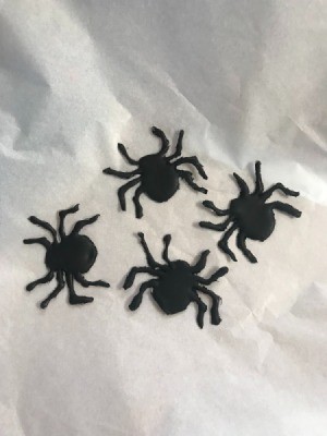 How to Make Hot Glue Spiders - four spiders on white paper background