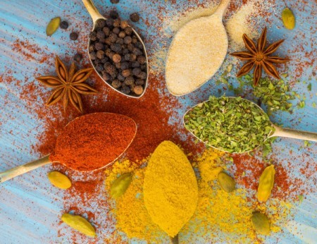 A selection of different spices, both powdered and whole.