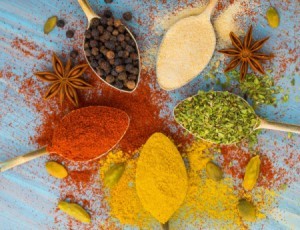 A selection of different spices, both powdered and whole.