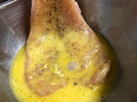dipping chicken breast in egg