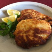 Chicken Schnitzel on plate with lemon bridges