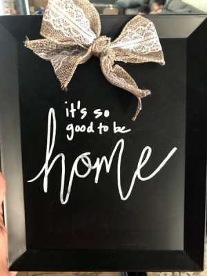 A decorative chalkboard with a bow.