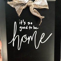 A decorative chalkboard with a bow.