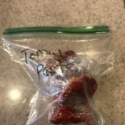 A tablespoon of tomato paste in a plastic bag.