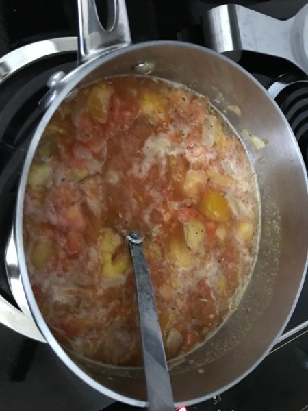 adding tomato paste to pan
