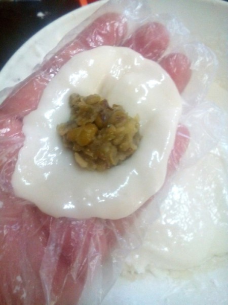 flattened dough ball with filling on top