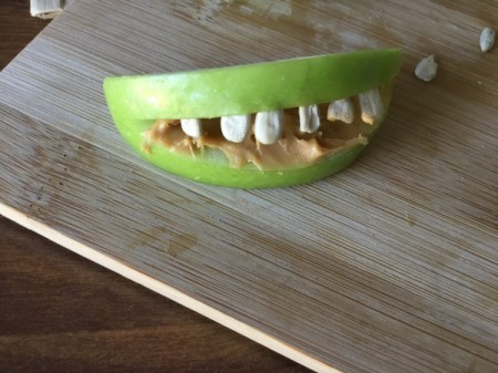 Green Apple Monsters - coat inside of wedge cut out with peanut butter and stick in sunflower seeds as teeth