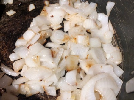 cooking chopped onions in pan Potatoes (Keema Aloo)