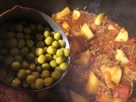 adding peas to stew