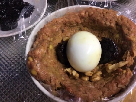 adding egg, garlic and plums to meat