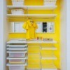 Yellow closed with drawers and shelves.