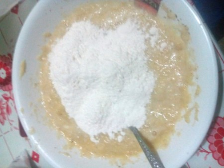 adding flour to batter