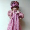 Identifying a Porcelain Doll - doll wearing a long pink dress and matching hat
