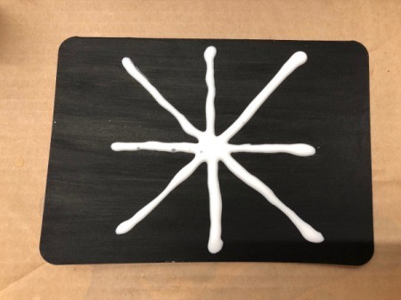 Salt Spider Web Painting - add two more crossing lines of glue for the base structure of the web