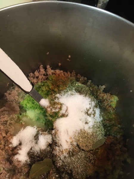 adding seasoning to pot