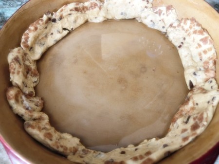 lining pie pan with cinnamon roll dough