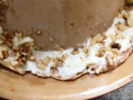 sprinkling walnuts on dough