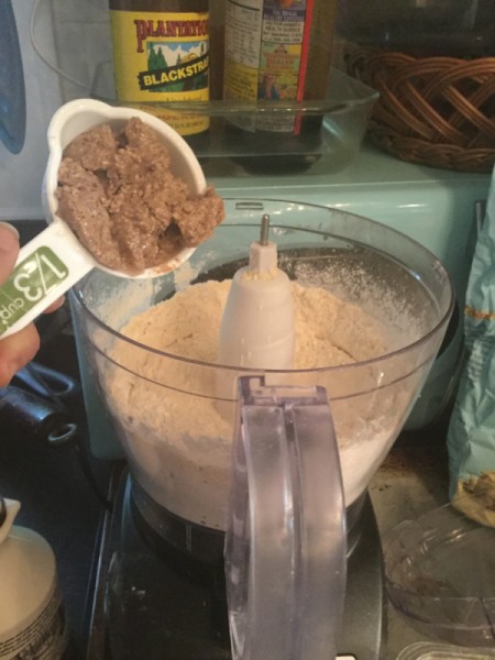 adding nut butter to processor