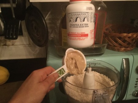 adding nut butter to processor