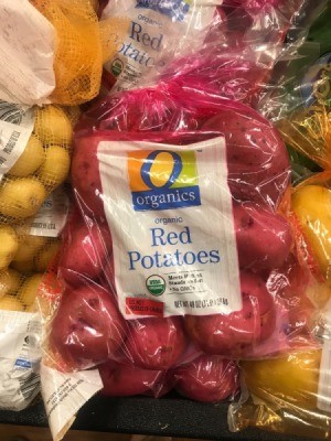 A colored bag of red potatoes.