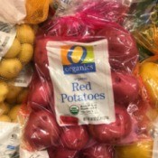 A colored bag of red potatoes.