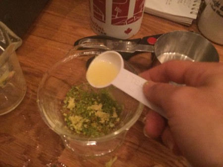 adding Lemon juice to lemon zest and grated ginger