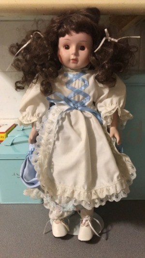 Identifying a Porcelain Doll - doll with dark brown curly pigtails and white dress with lace