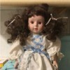 Identifying a Porcelain Doll - doll with dark brown curly pigtails and white dress with lace