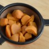 A strainer with canned yams.