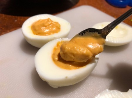 adding filling to egg white halves