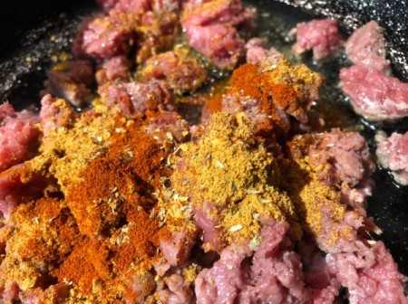 ground meat and spices in pan