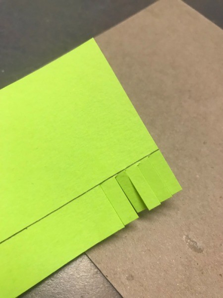 Birthday Cake Gift Box - draw a line 3/4 of an inch in from the edge of the wider strip and snip all along the edge to the line