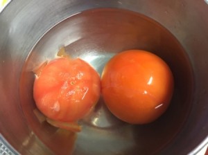 Tomato skins being removed after blanching.