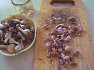 A cutting board full of very small garlic cloves.
