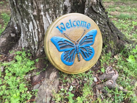 Making a Welcome Stepping Stone - finished stone with lettering and butterfly painted blue