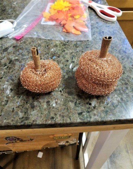 Dollar Tree Tiny Scrubber Pumpkins - use hot glue to attach the sticks as the stems
