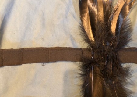 Raven Masquerade Costume - cut 2 strips of fabric 2 yards long and attach the more wispy feathers to one of them then sew the second on top