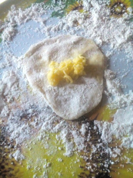 cheese added to flattened dough