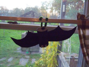 Hanging Bats - bat hanging in the window from a curtain rod