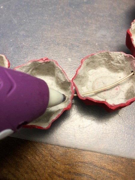 Christmas Egg Carton Wreath - put dabs of hot glue near the holes to keep the cups from turning and moving on the wire