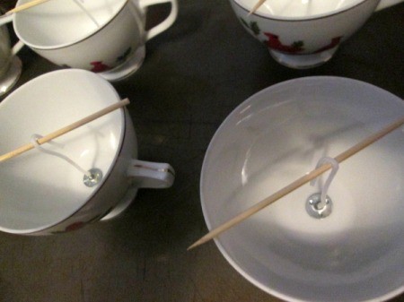 Using Leftover Candle Wax For Gifts - skewers over cups with the wicks attached