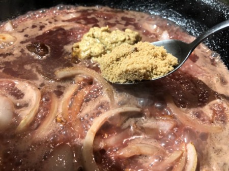 adding spices to sauce