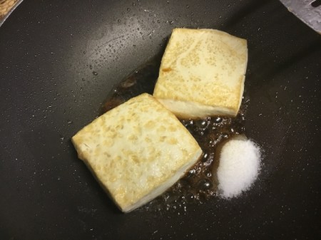 adding sugar and soy sauce to pan