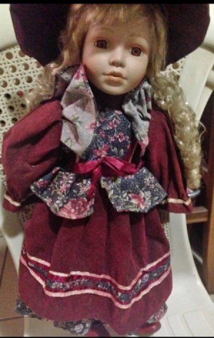 Identifying a Porcelain Doll - doll wearing wine colored dress and matching hat with a floral vest