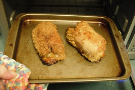 heating Mozzarella and Ham Chicken Thighs on baking tray