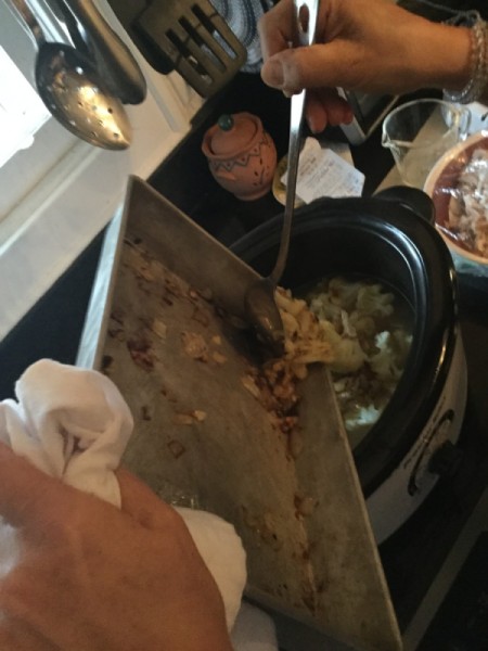 adding chicken to stew pot