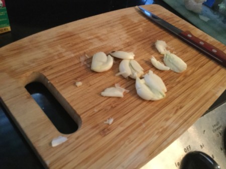 garlic cloves on cutting board
