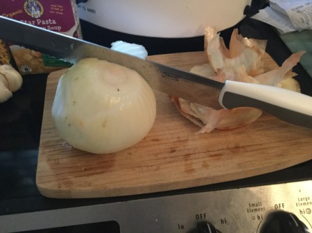 chopping onion on cutting board
