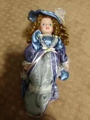 Value of a Limited Edition J. Misa Porcelain Doll - doll in blue satin dress with a matching hat