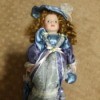 Value of a Limited Edition J. Misa Porcelain Doll - doll in blue satin dress with a matching hat